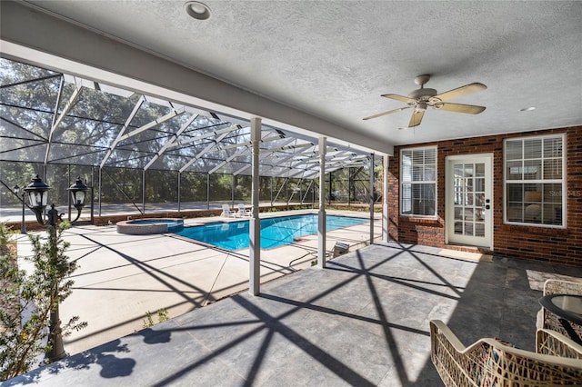 view of swimming pool featuring a patio, glass enclosure, and an in ground hot tub