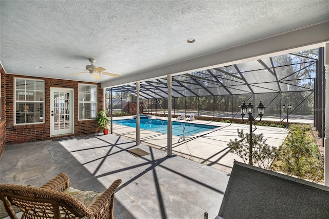 view of pool featuring ceiling fan, a lanai, and a patio