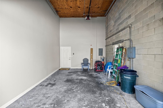 garage with wood ceiling, a garage door opener, and electric panel