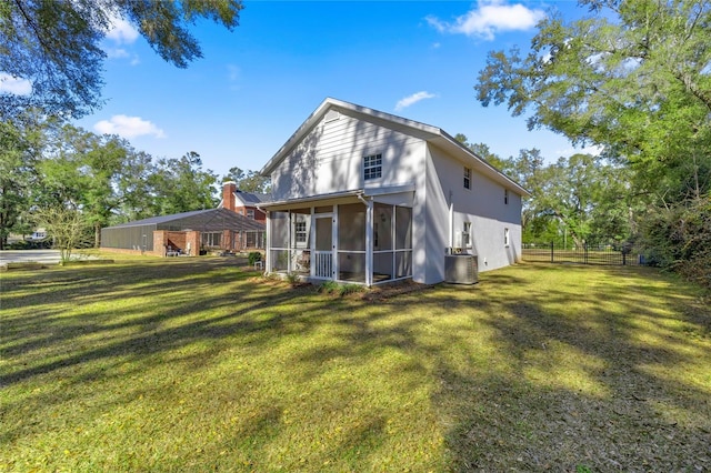 back of property with central AC, a lawn, and a sunroom