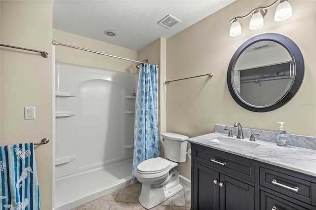 bathroom with vanity, a textured ceiling, curtained shower, tile patterned floors, and toilet