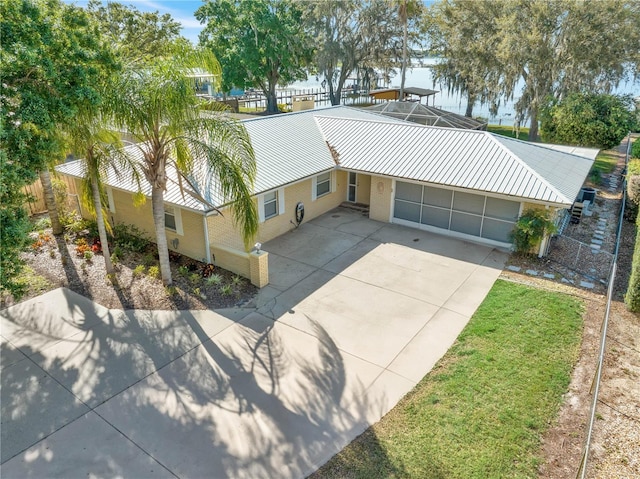 view of front of home with a garage and a lanai