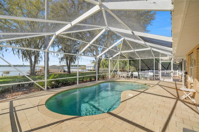 view of pool with a water view, a lanai, and a patio area