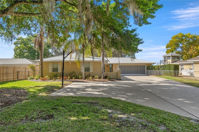 single story home featuring a garage and a front lawn