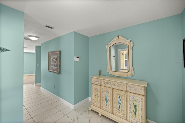 hall featuring light tile patterned floors