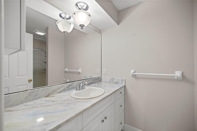 bathroom featuring an enclosed shower and vanity