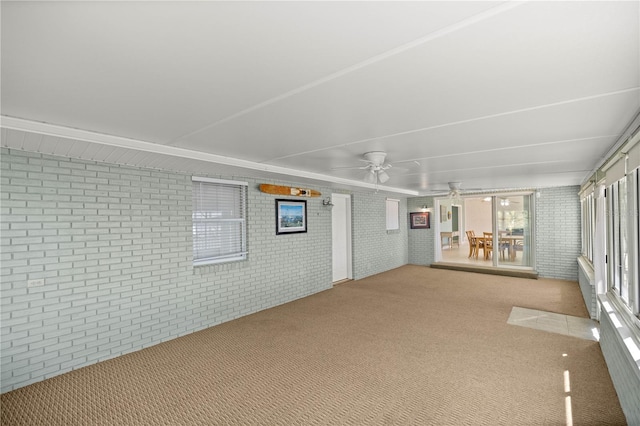 unfurnished sunroom featuring ceiling fan