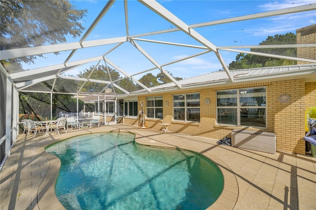 view of swimming pool with a lanai and a patio area