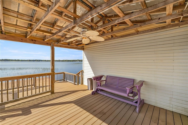 wooden deck with a water view and ceiling fan