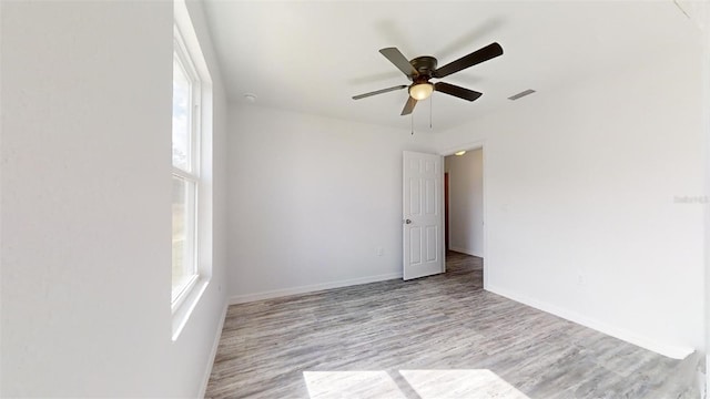 spare room featuring ceiling fan and light hardwood / wood-style floors