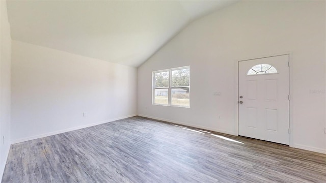 entrance foyer featuring high vaulted ceiling and light hardwood / wood-style floors