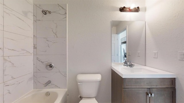 full bathroom with vanity, tiled shower / bath combo, and toilet