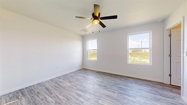 empty room featuring ceiling fan and light hardwood / wood-style floors