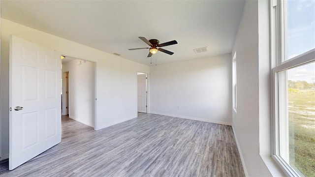 spare room featuring ceiling fan and light hardwood / wood-style floors