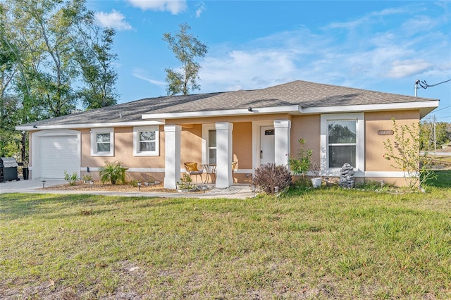 single story home featuring a garage, a front yard, and covered porch