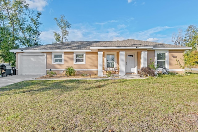 ranch-style house featuring a garage and a front lawn