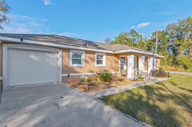 single story home featuring a garage and a front yard