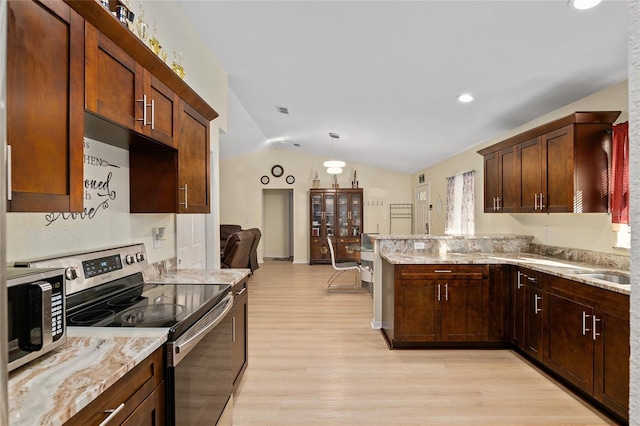 kitchen with lofted ceiling, stainless steel appliances, light stone countertops, light hardwood / wood-style floors, and decorative light fixtures