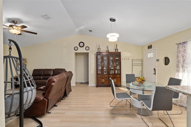 dining space featuring vaulted ceiling, ceiling fan, and light wood-type flooring