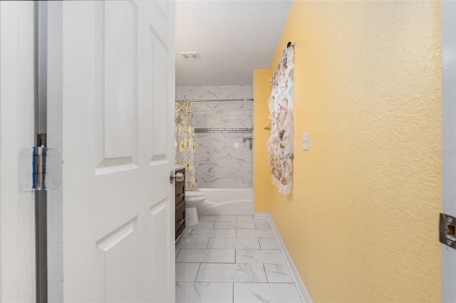 bathroom with toilet and shower / tub combo