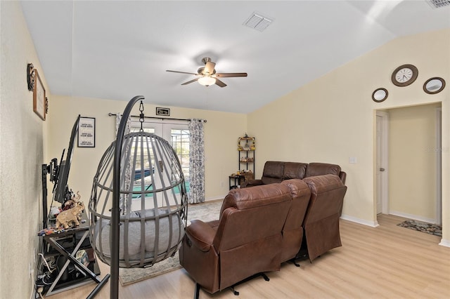 living room with lofted ceiling, ceiling fan, and light hardwood / wood-style flooring