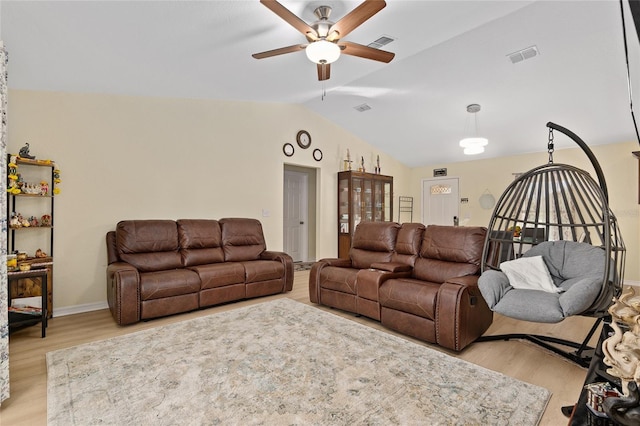 living room with ceiling fan, lofted ceiling, and light hardwood / wood-style floors