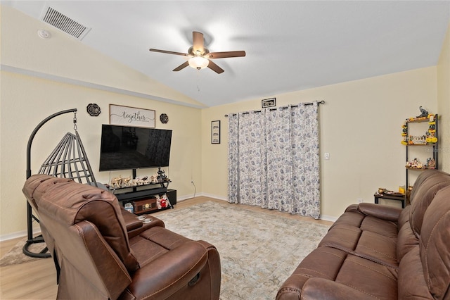 living room featuring vaulted ceiling, ceiling fan, and light wood-type flooring