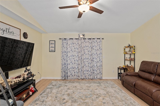 living room featuring ceiling fan and light wood-type flooring