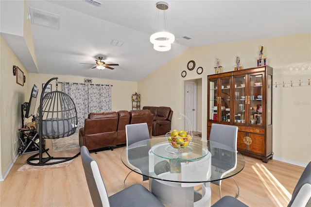 dining area featuring vaulted ceiling, light hardwood / wood-style floors, and ceiling fan