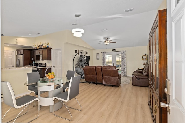 dining room with vaulted ceiling, light hardwood / wood-style floors, french doors, and ceiling fan