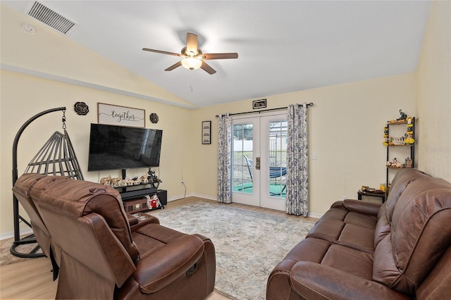 living room with french doors, ceiling fan, lofted ceiling, and light hardwood / wood-style flooring