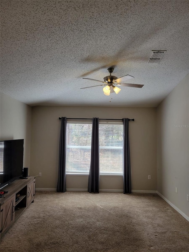 unfurnished living room featuring a textured ceiling, light colored carpet, and ceiling fan