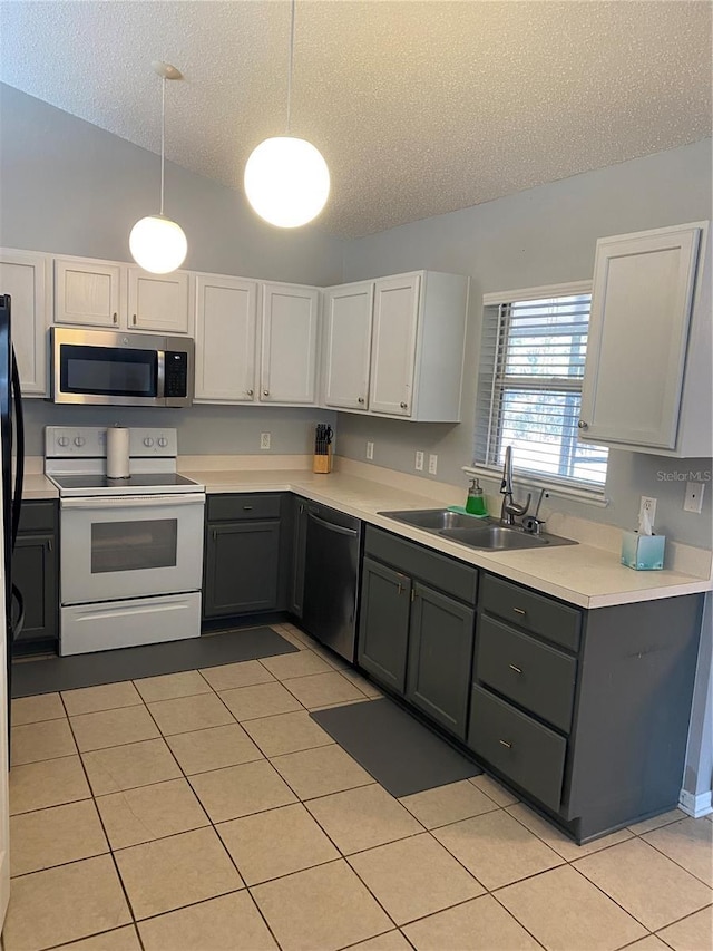 kitchen with pendant lighting, white electric stove, sink, black dishwasher, and white cabinets