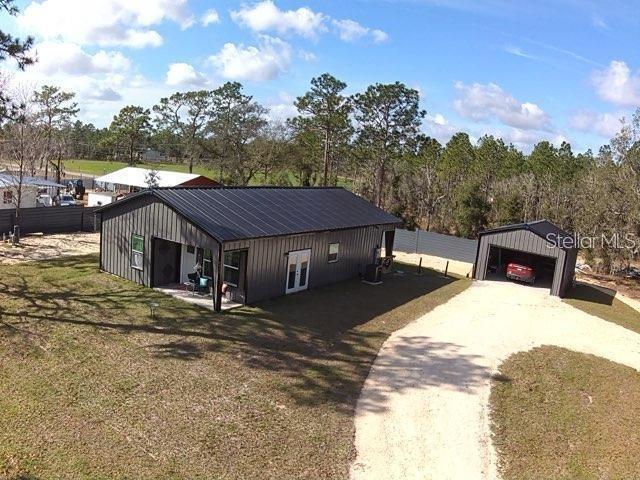 exterior space with an outbuilding, a garage, and a front lawn