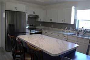 kitchen with white cabinetry, appliances with stainless steel finishes, and a center island