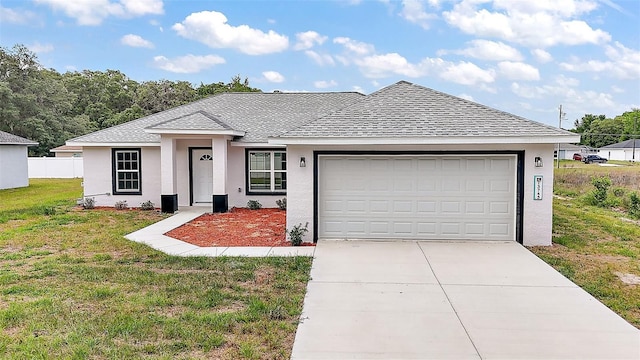 13743 SW 113th Ln, Dunnellon, FL 34432 - view of front of house featuring a front yard, roof with shingles, stucco siding, concrete driveway, and an attached garage