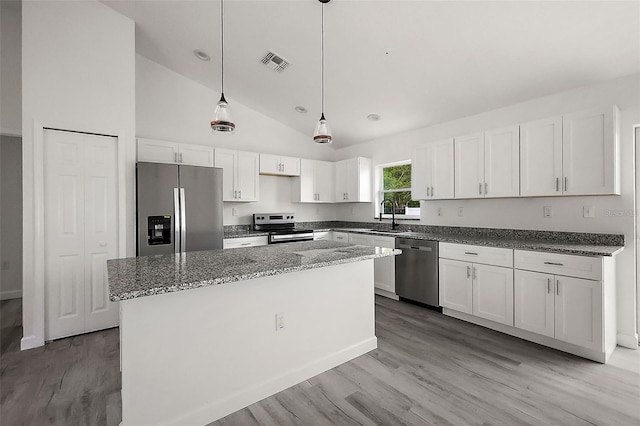 13743 SW 113th Ln, Dunnellon, FL 34432 - kitchen with light wood-style floors, appliances with stainless steel finishes, white cabinetry, and visible vents