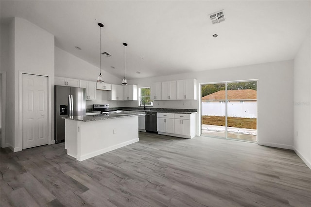 13743 SW 113th Ln, Dunnellon, FL 34432 - kitchen with a kitchen island, visible vents, appliances with stainless steel finishes, wood finished floors, and white cabinetry