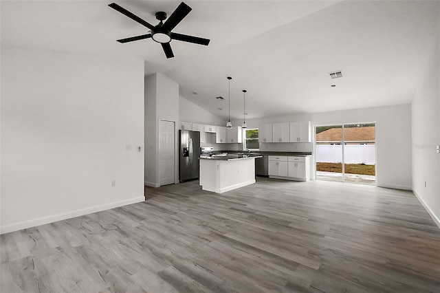 13743 SW 113th Ln, Dunnellon, FL 34432 - kitchen with white cabinetry, open floor plan, dark countertops, and stainless steel fridge with ice dispenser