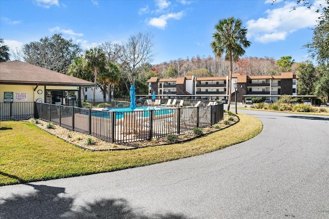 view of pool with a yard