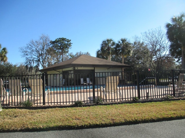 view of swimming pool featuring a patio and a yard