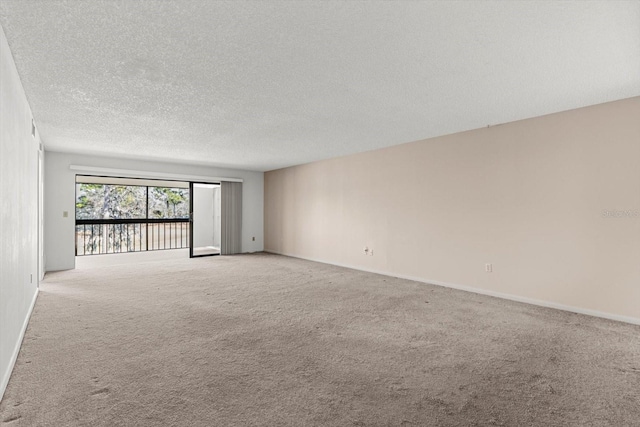 carpeted empty room with a textured ceiling