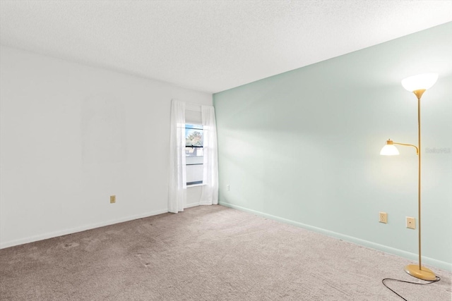 carpeted spare room with a textured ceiling