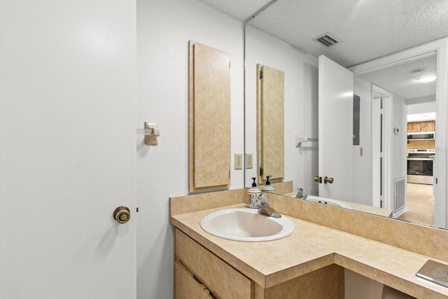 bathroom featuring vanity and a textured ceiling