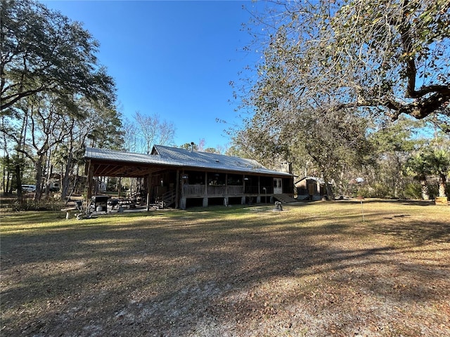 rear view of property with a lawn