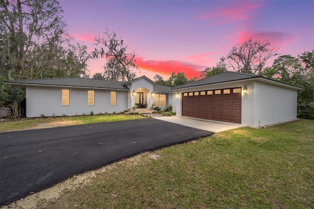 view of front of house with a yard and a garage