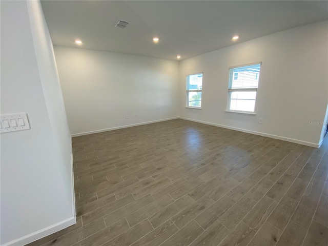 empty room featuring dark hardwood / wood-style flooring