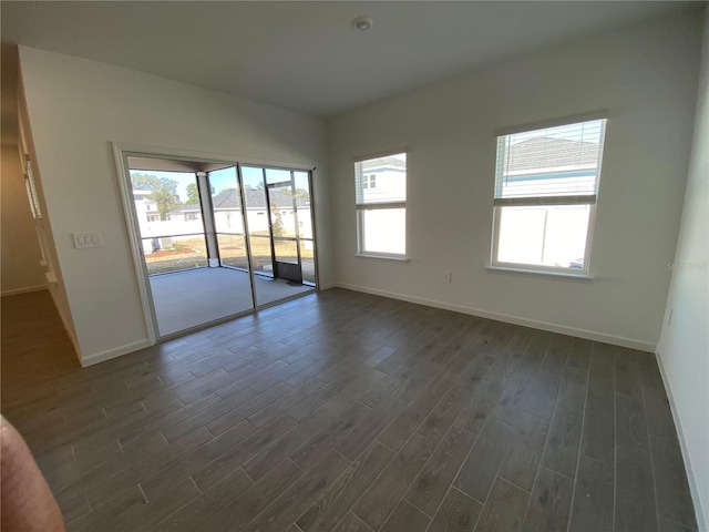 spare room with dark hardwood / wood-style flooring