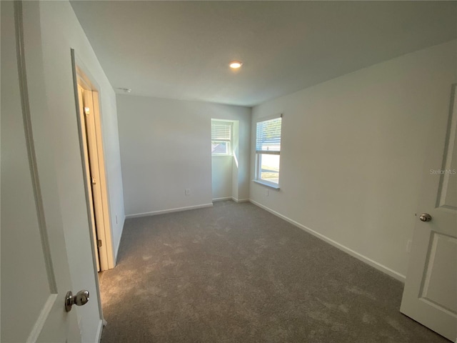 unfurnished bedroom featuring dark carpet