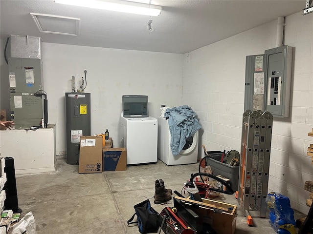 basement with water heater, washing machine and clothes dryer, heating unit, and electric panel